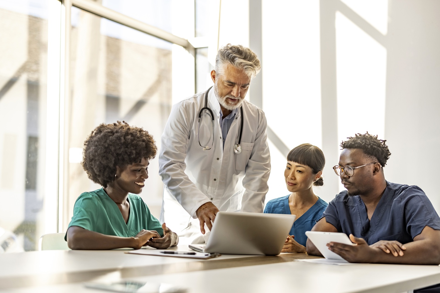 Diverse Medical Team Collaborates in Bright Office Setting Antibiotic Stewardship in Urgent Care - An Operator and Medical Director Playbook