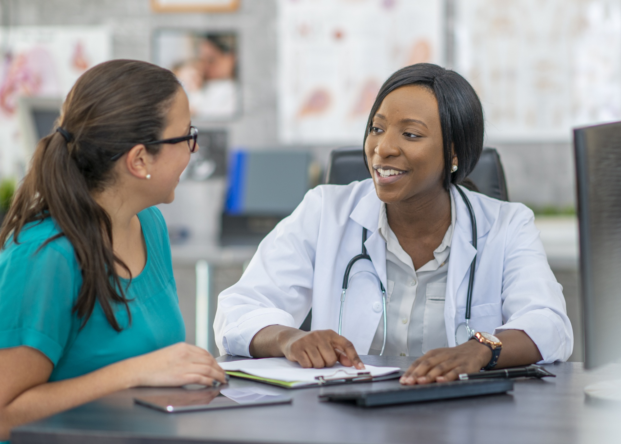 Women and UTIs Webinar Women and UTIs Webinar - A young adult woman at a medical appointment with a female doctor